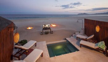 Outdoor Beach Cinema on the sand with the ocean in the background