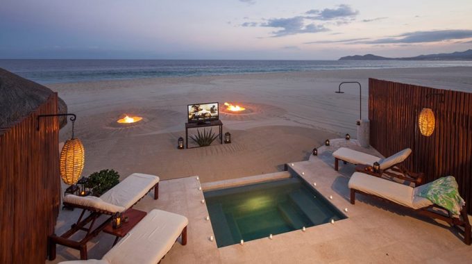 Outdoor Beach Cinema on the sand with the ocean in the background