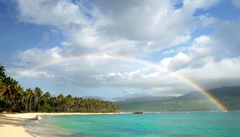 picturesque-beach-rainbow-over-turquoise-water