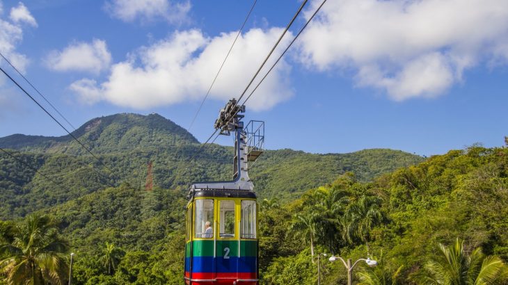 colorful-cable-car-hanging-green-lush-mountain-backdrop