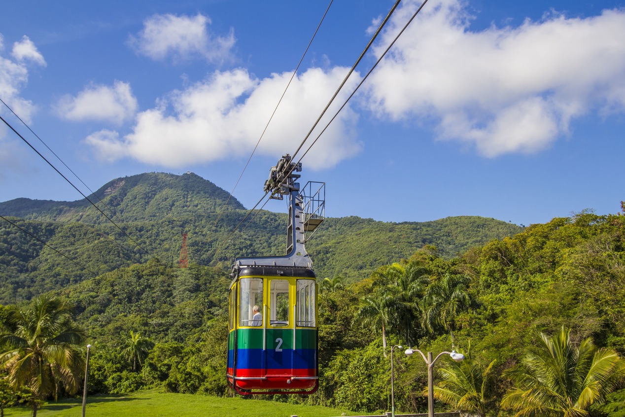 colorful-cable-car-hanging-green-lush-mountain-backdrop