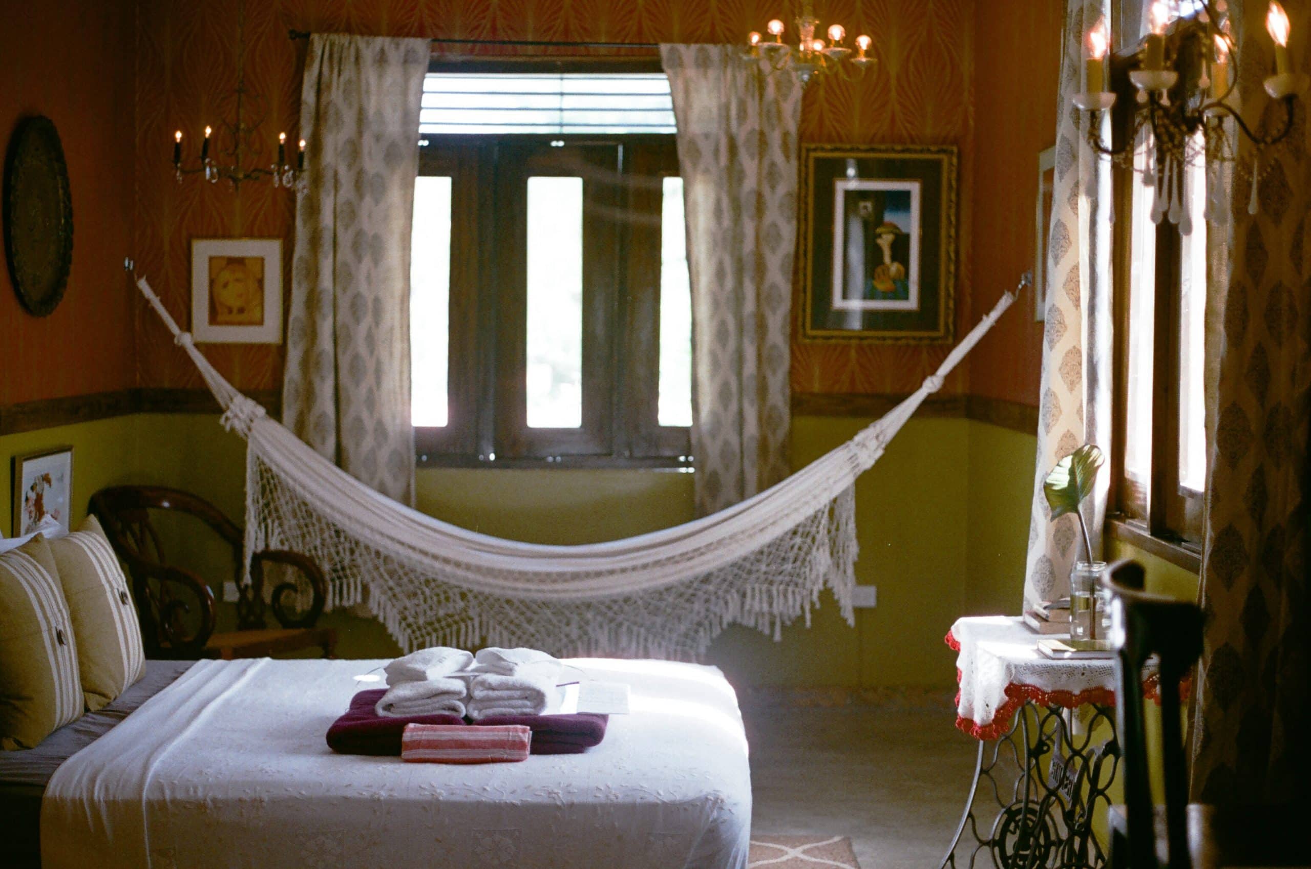 A hammock and cozy bed in a bedroom of the Dreamcatcher hotel