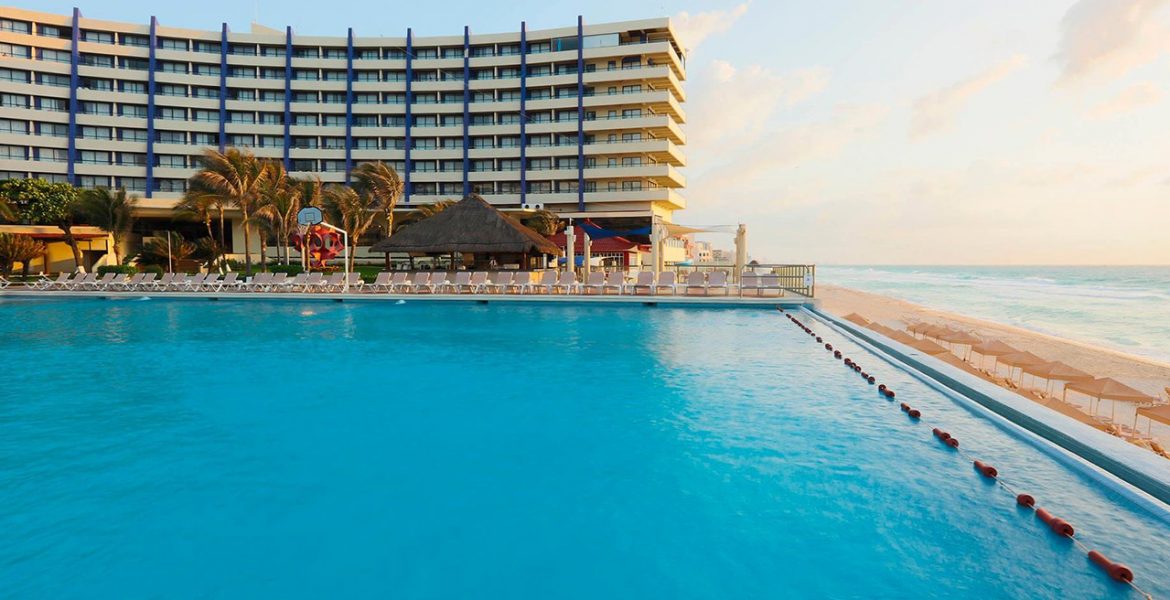 resort-pool-white-hotel-building-sunset