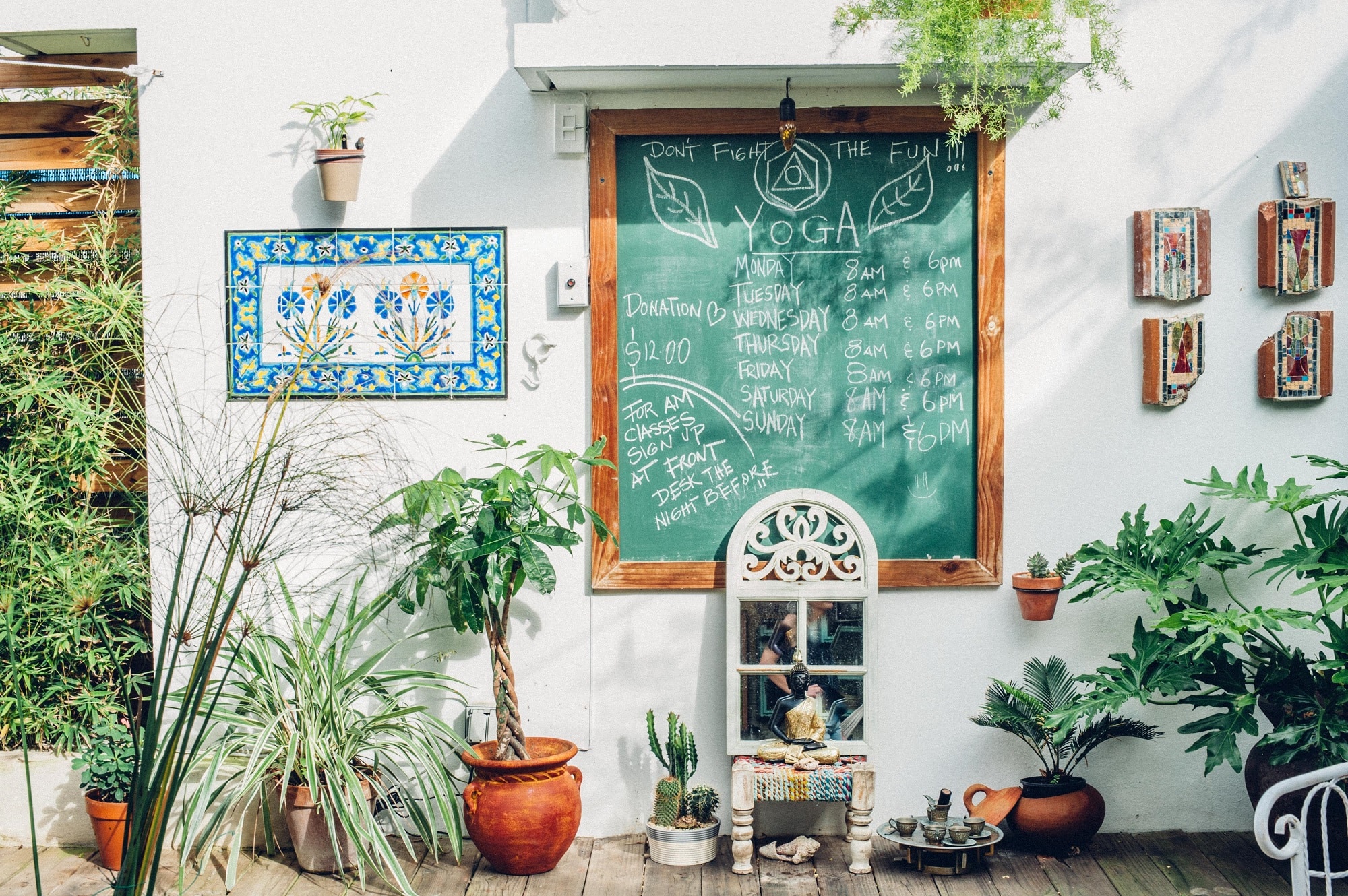 A chalkboard in the courtyard of the Dreamcatcher lists all of the yoga classes from which guests can choose