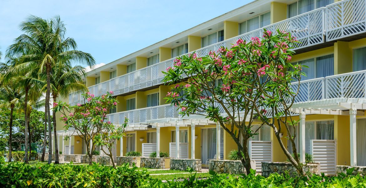 resort-building-yellow-surrounded-green-grass-plants