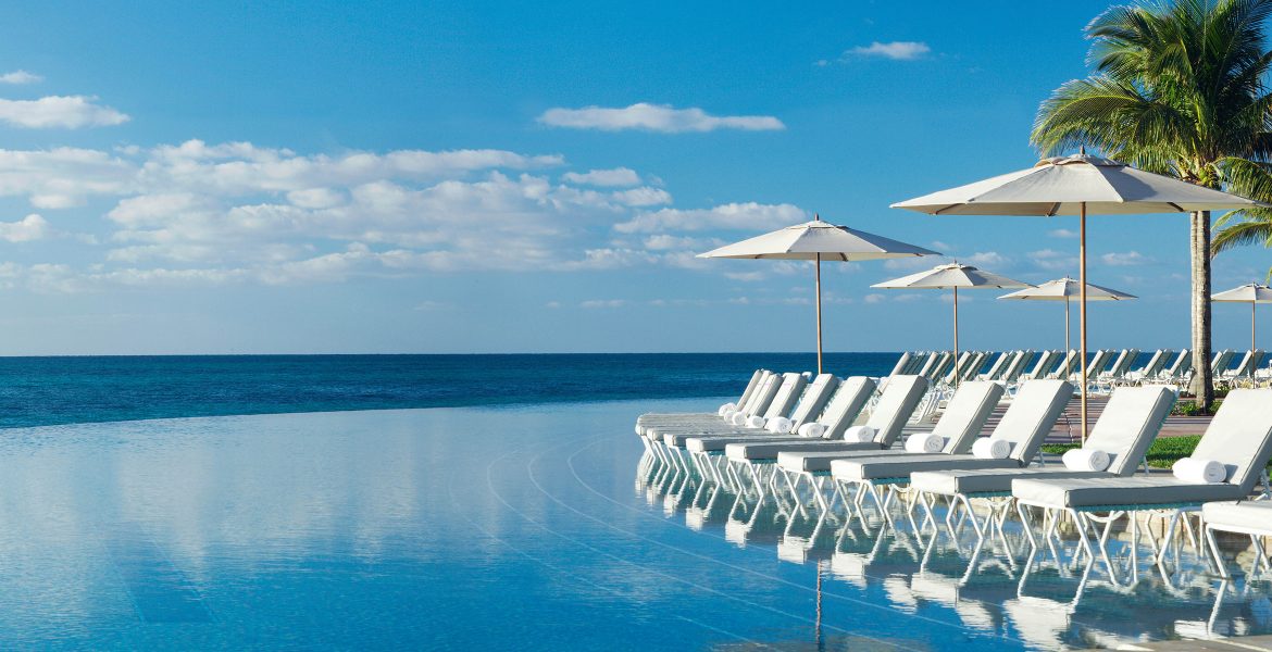 ocean-front-pool-white-umbrellas-loungers