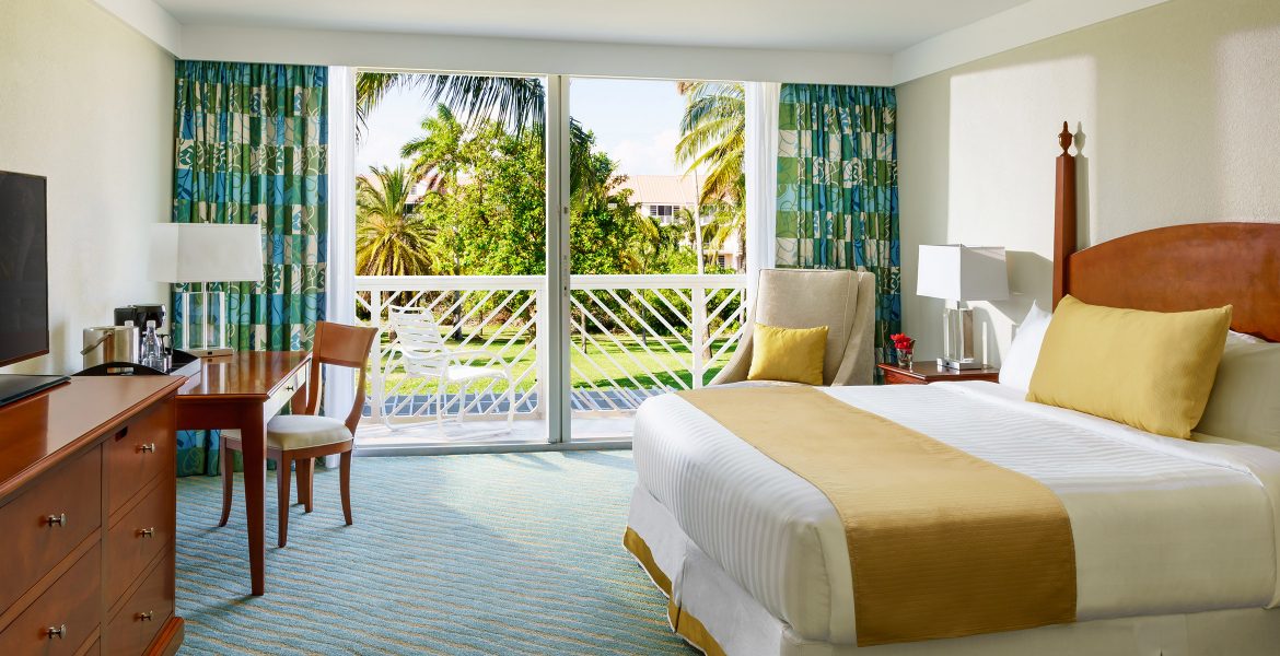 hotel-room-sliding-glass-doors-view-green-trees