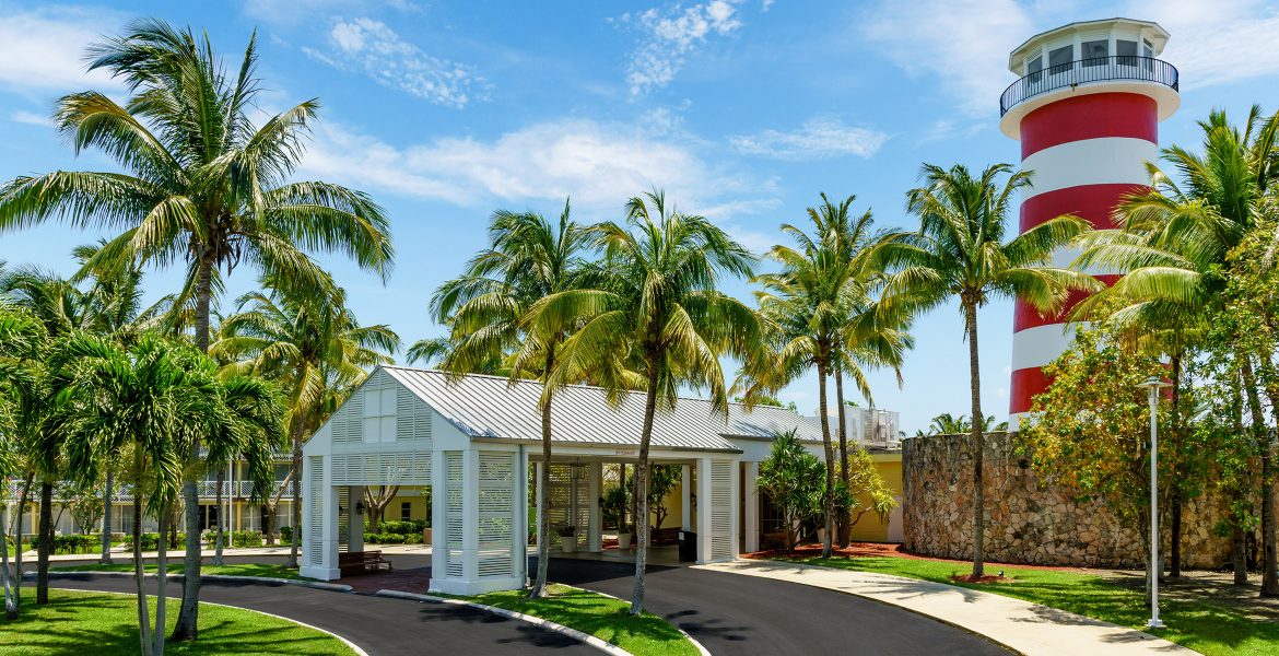 entrance-resort-green-palm-trees-blue-sky