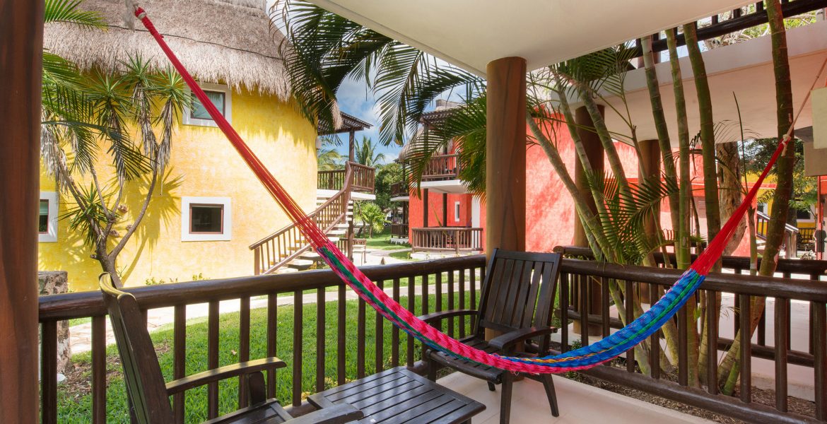 hotel-room-patio-with-pink-hammock-other-colorful-buildings