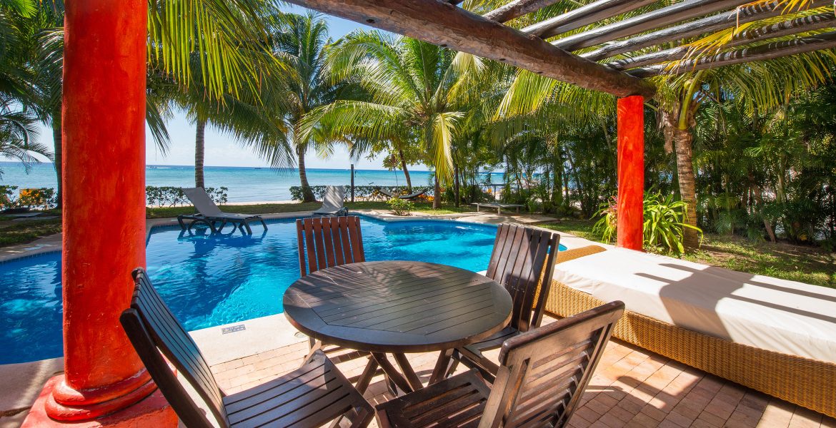 table-next-to-beach-front-pool