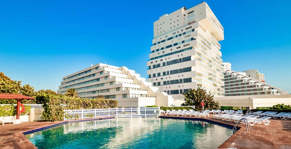 white-resort-building-turquoise-pool