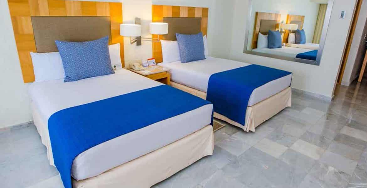 resort-suite-two-white-beds-blue-accents