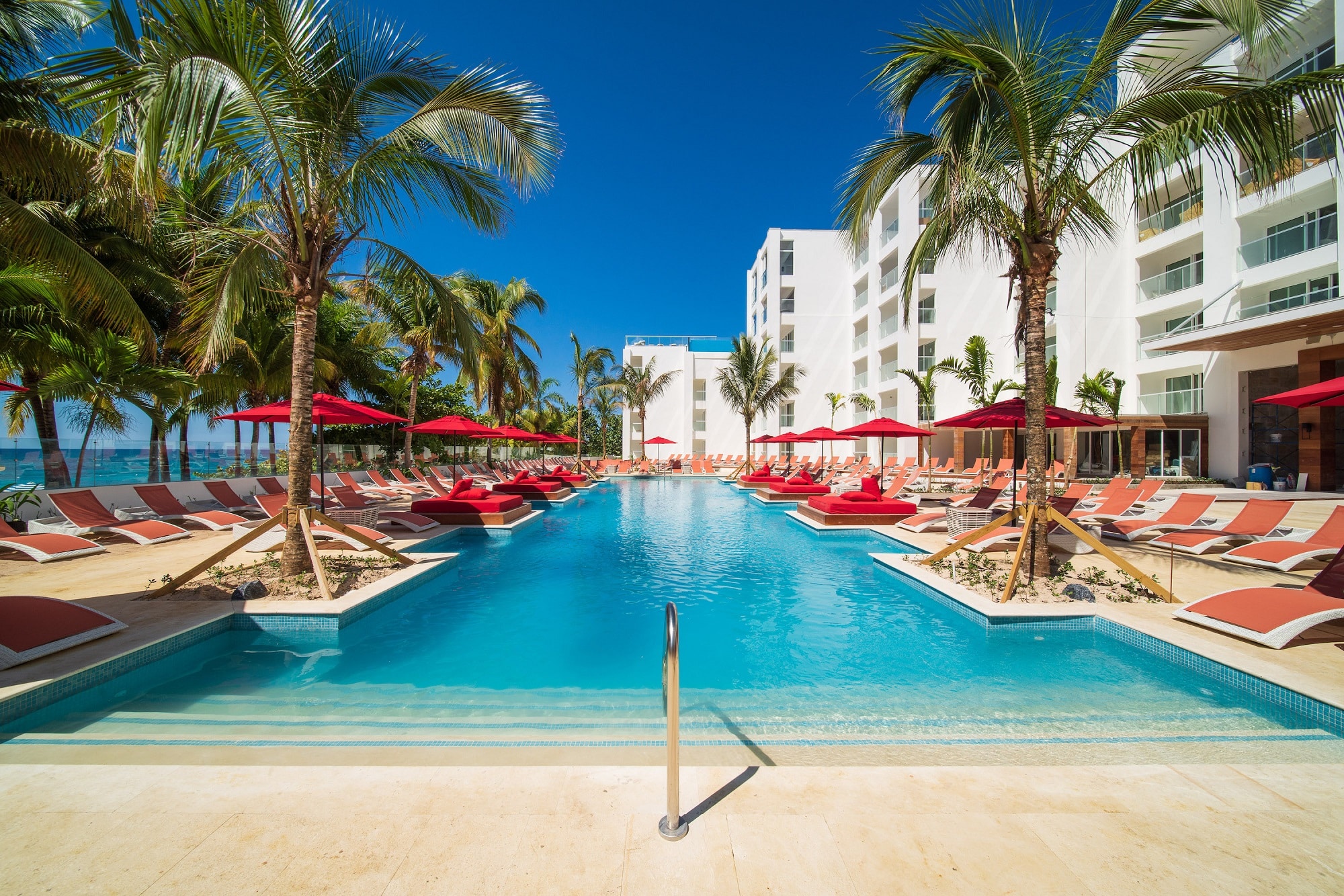 Entrance to the main pool at the S Hotel Montego Bay with sunbeds and umbrelllas