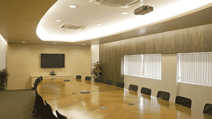 neutral-toned-conference-room-table-screen-chairs