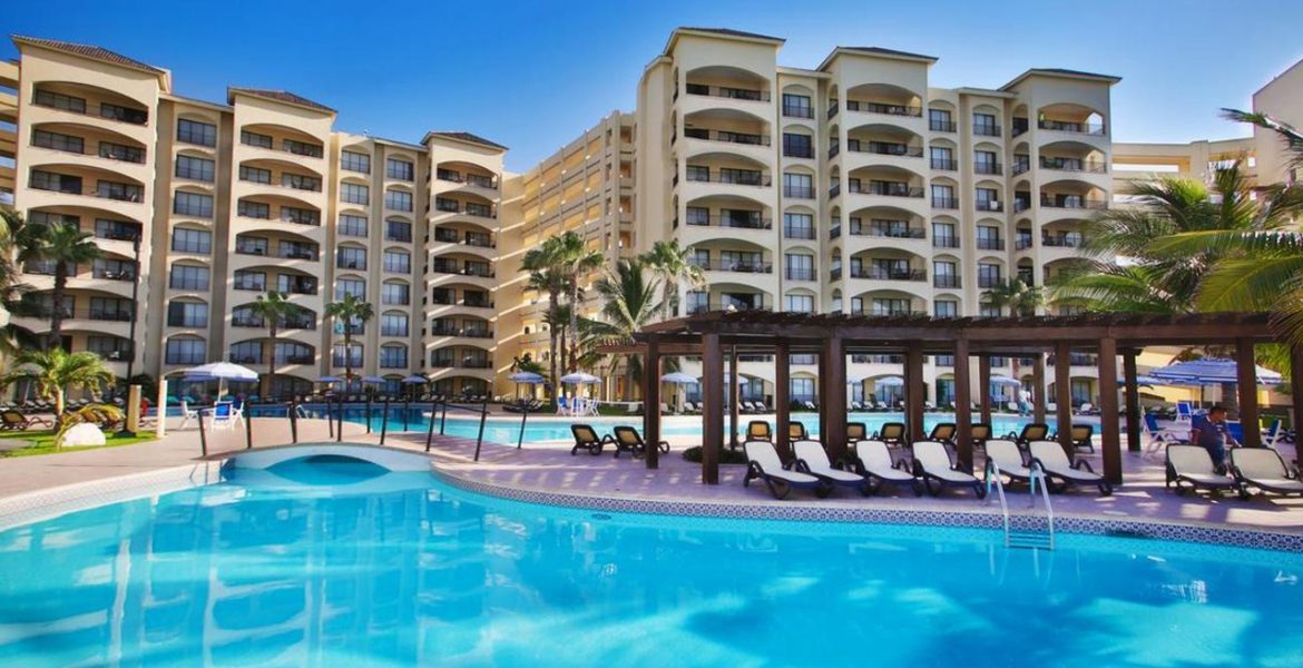 resort-building-blue-pool-and-loungers