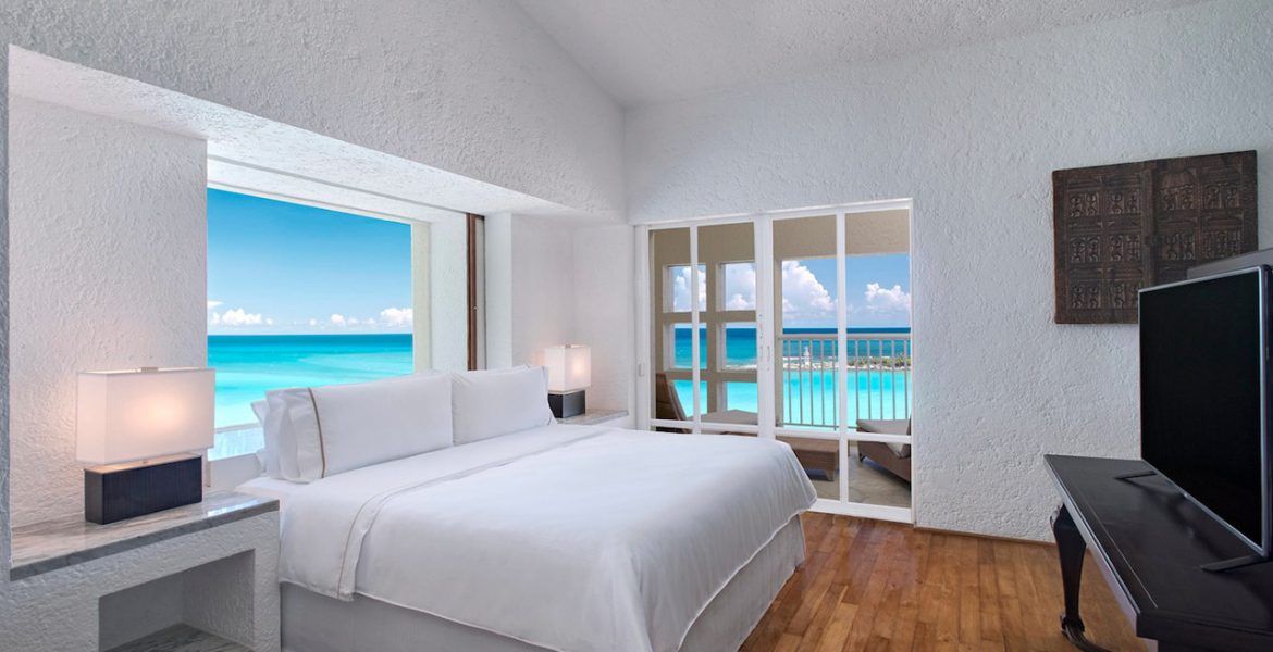 resort-suite-white-bed-balcony-overlooking-ocean