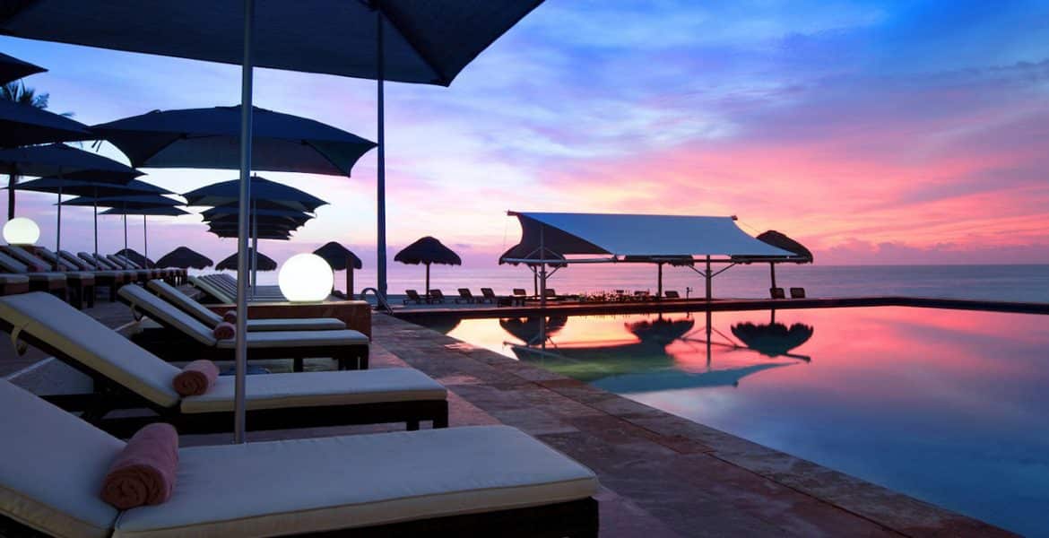 resort-pool-loungers-sunset