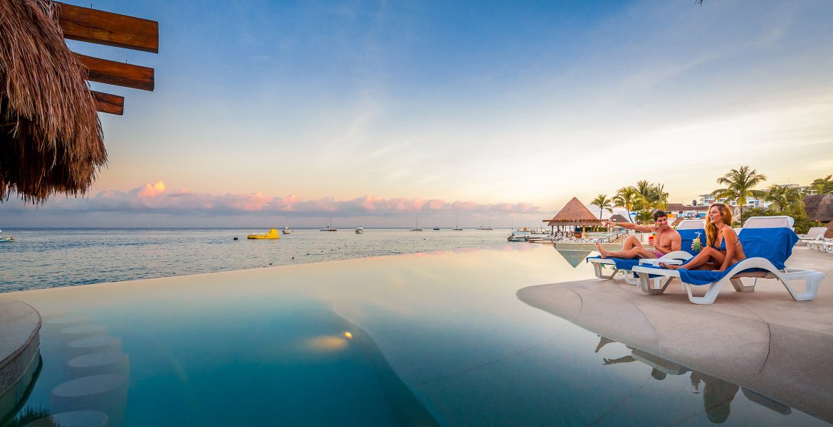 beach-hotel-pool-overlooking-ocean-sunset