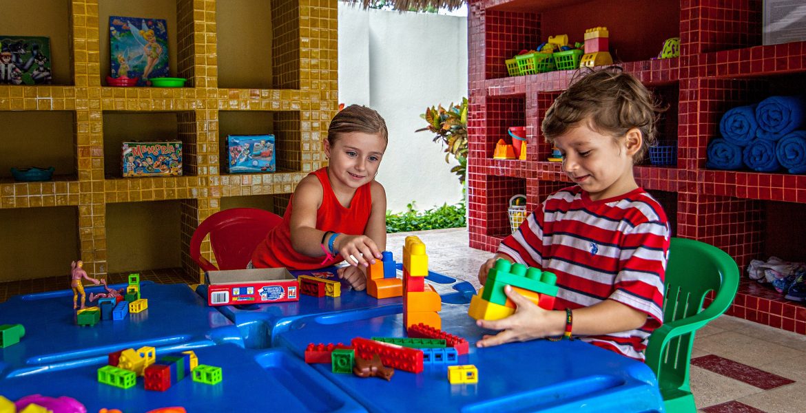 children-playing-resort-kids-club-blue-table-blocks