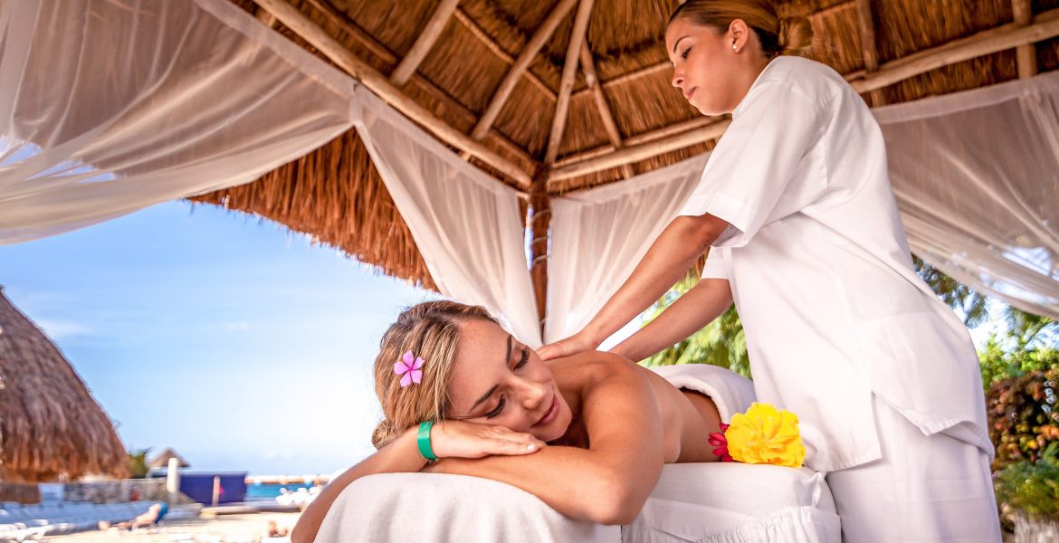 woman-receiving-massage-in-beach-cabana