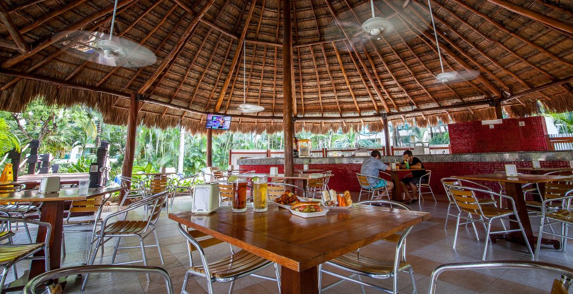 open-air-dining-under-palm-thatched-roof