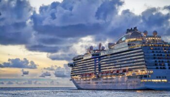 A cruise ship on the water at sunset