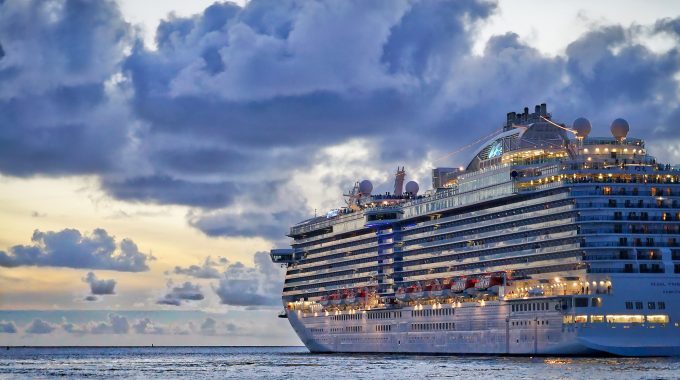 A cruise ship on the water at sunset