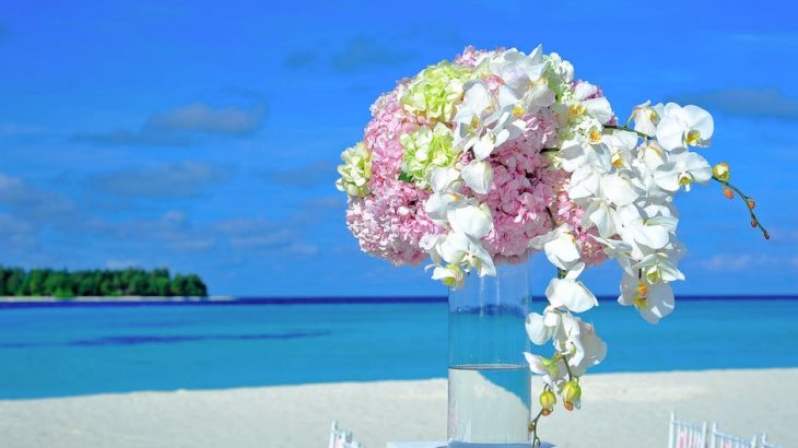 wedding-bouquet-on-table-on-beach-ocean-behind