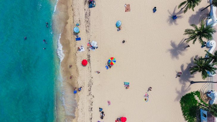 aerial-view-golden-sand-beach-colorful-umbrellas-people-turquoise-ocean