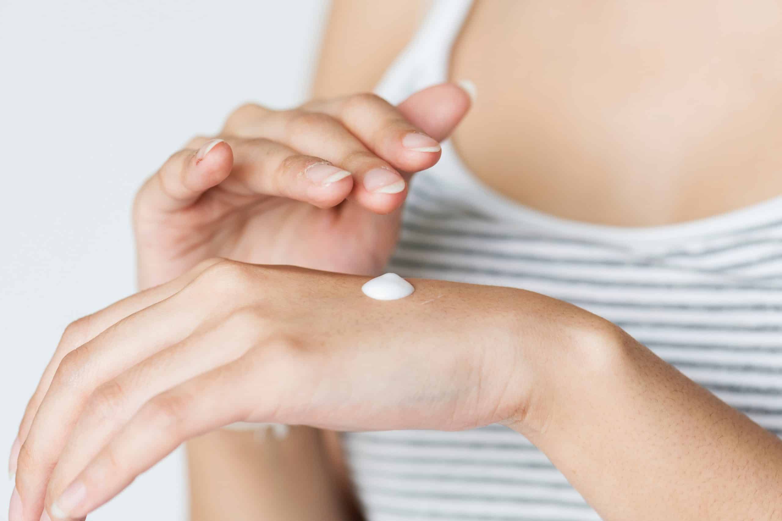 Person applying sunscreen to their hand