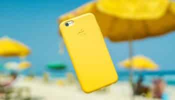 yellow-iphone-floating-beach-background-blurred-white-sand-yellow-umbrellas