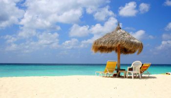 beach-umbrella-hut-chairs-turquoise-water-aruba