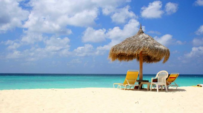 beach-umbrella-hut-chairs-turquoise-water-aruba