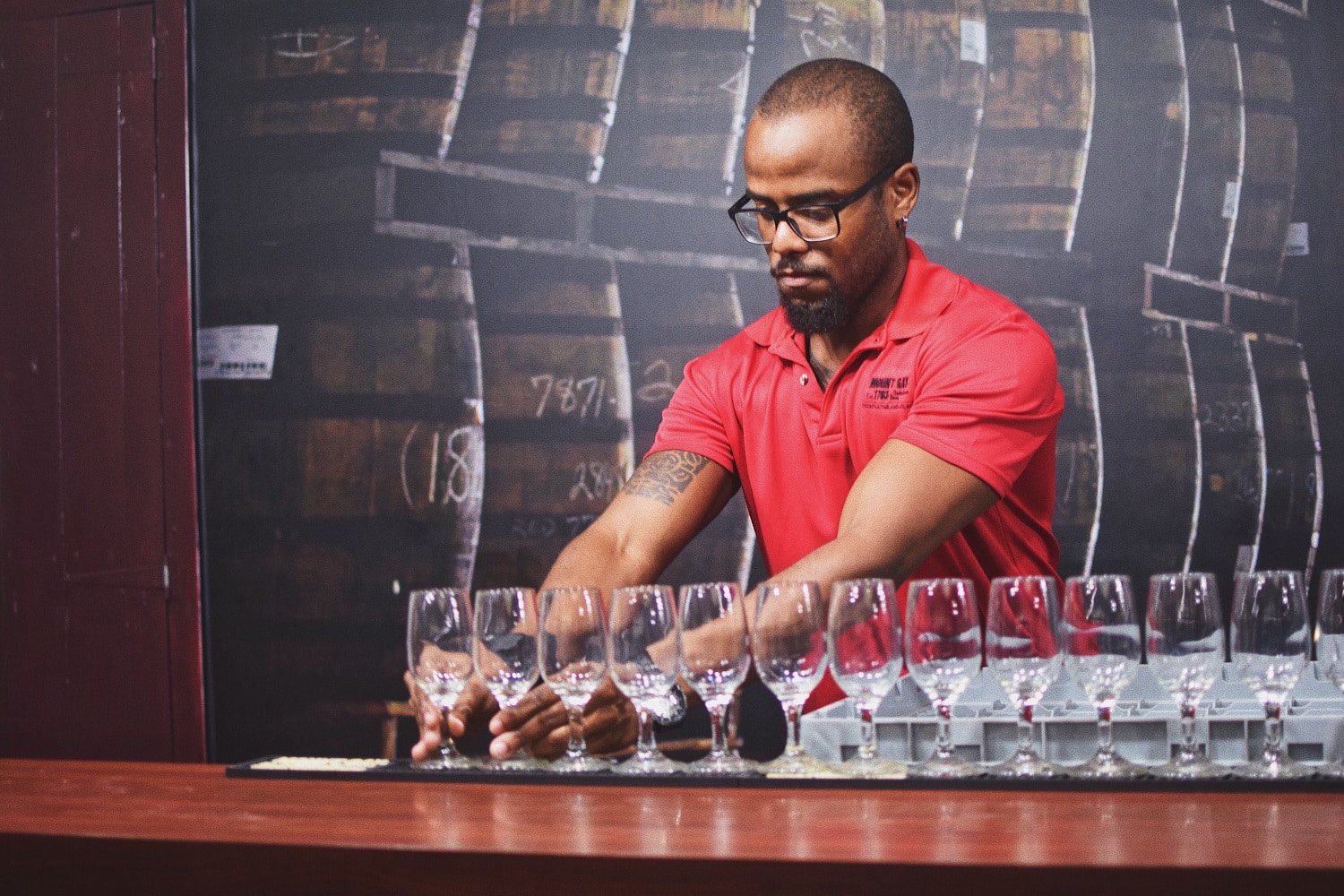 A bartender prepares tasting glasses for rum