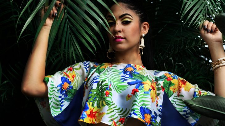 girl-wearing-colorful-shirt-under-palm-fronds