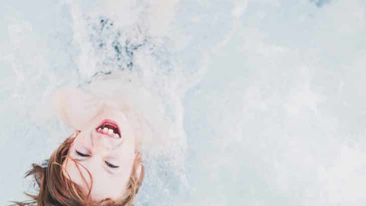 child-boy-in-pool-looking-up-smiling