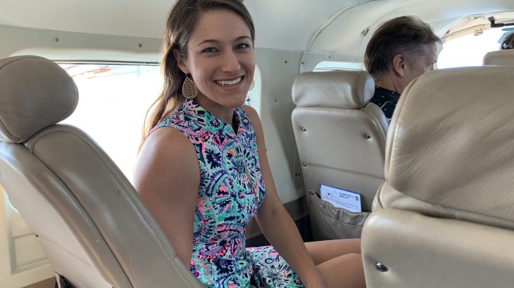 woman-in-sea-plane-colorful-dress