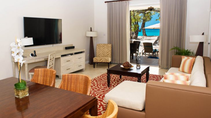 Living room overlooking ocean at Spice Island Beach Resort