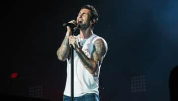 Image of Adam Levine male singer performing in white tank top