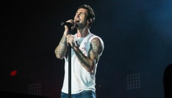 Image of Adam Levine male singer performing in white tank top