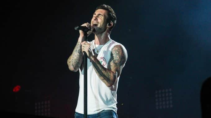 Image of Adam Levine male singer performing in white tank top