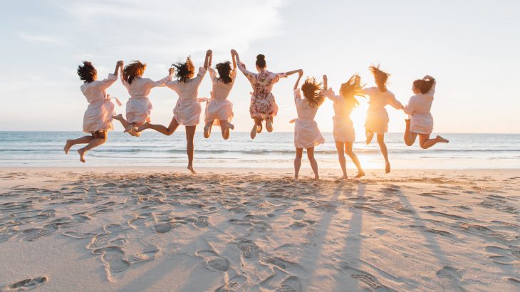 wedding-party-bridesmaids-jumping-beach