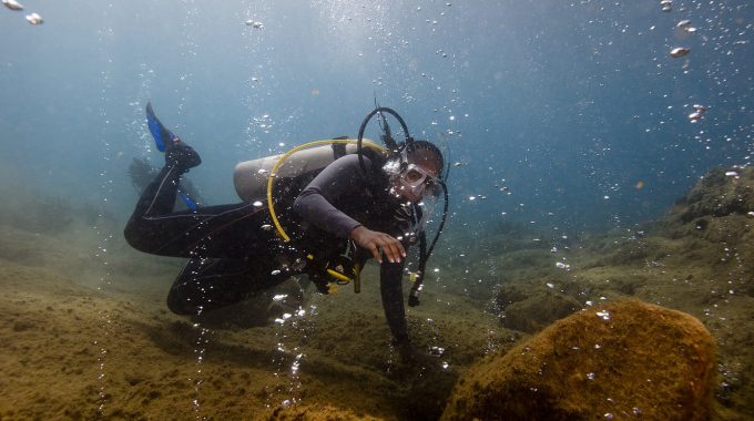 A diver looks at bubbles in the Champagne Reef