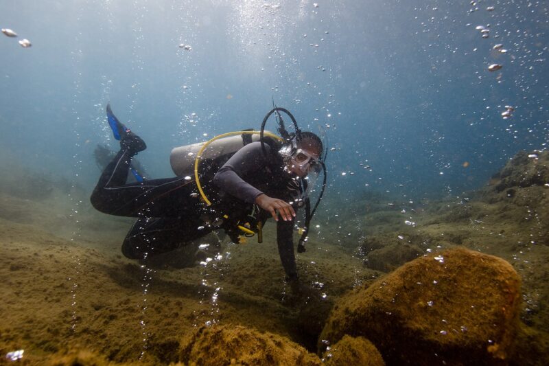 A diver looks at bubbles in the Champagne Reef