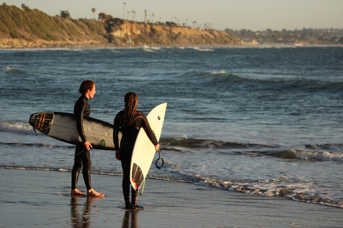 Two young surfers at Swami`s beach in Encinitas California.