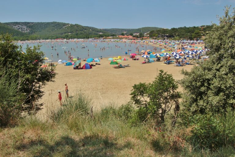 The crowded Paradise beach in summer, in the town and resort Lopar, Rab island, Croatia. South-east Europe.
