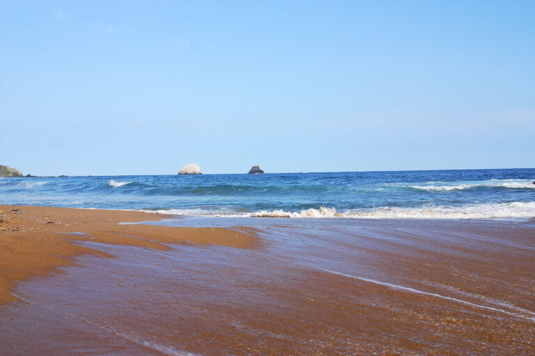 Partial view of a wave and a small island in the bay of San Agustinillo in the southern state of Oaxaca in Mexico