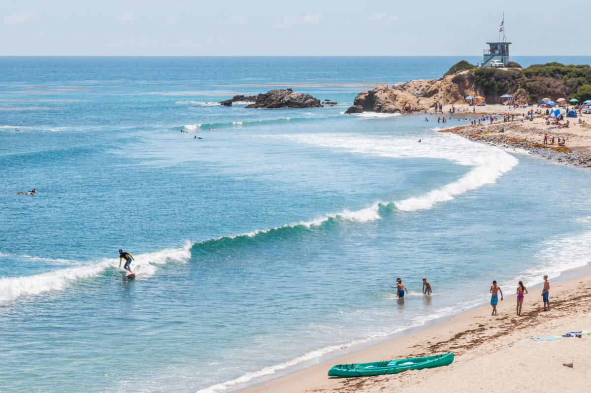 Surfers, swimmers and sunbathers enjoying a summer day in southern California.