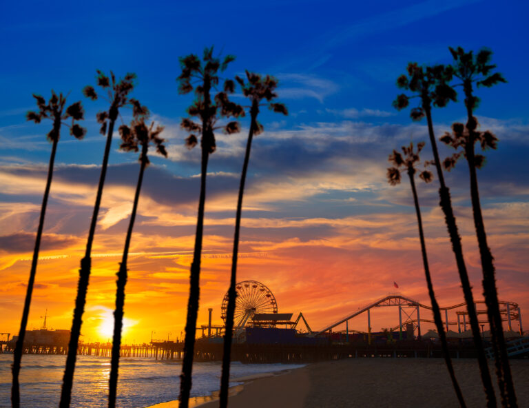 Santa Monica California sunset on Pier Ferrys wheel and reflection on beach wet sand