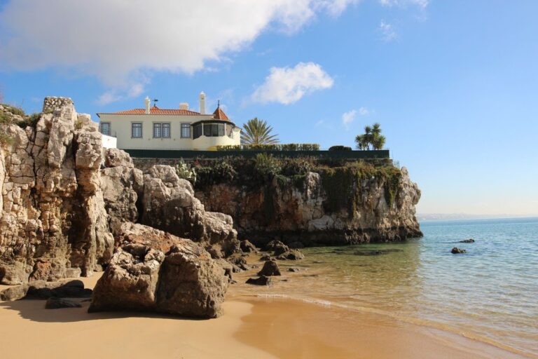 blue skies at small inlet beach in Cascais, Portugal